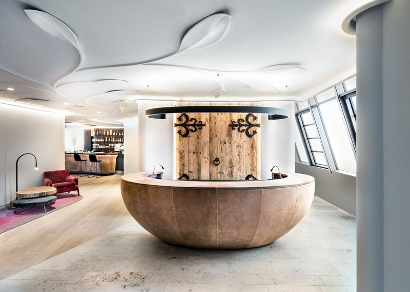 The lobby of this modern hotel draws inspiration from the historic town, with wood and black metal accents. #Lobby #HotelLobby #InteriorDesign