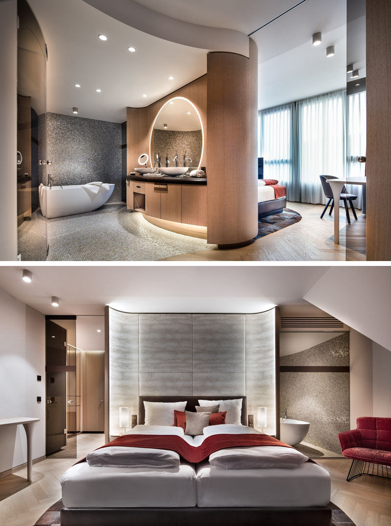 In this modern hotel room, the curved wood bathroom vanity and wall doubles as a curved accent wall for the bed. #HotelRoom #HotelBathroom #AccentWall #CurvedWall