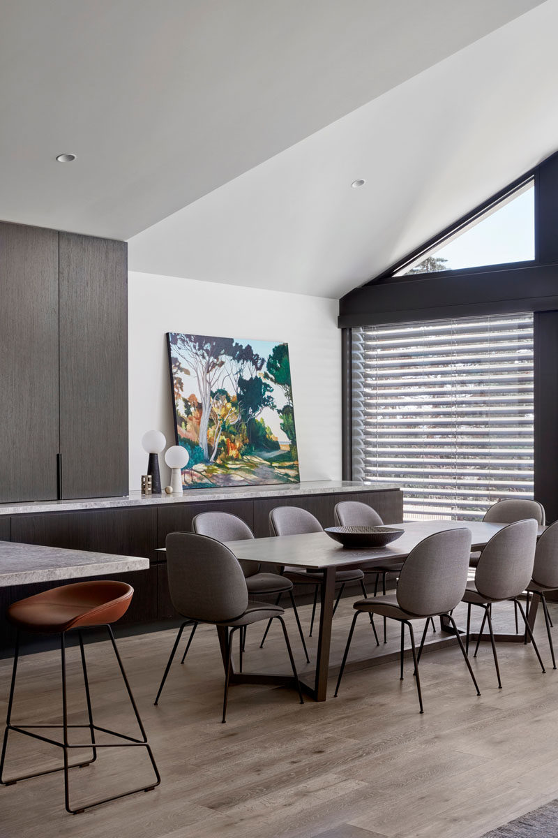 The counter and lower cabinets of the kitchen continuing through to this modern dining area, acting as a sideboard. #DiningArea #DiningRoom