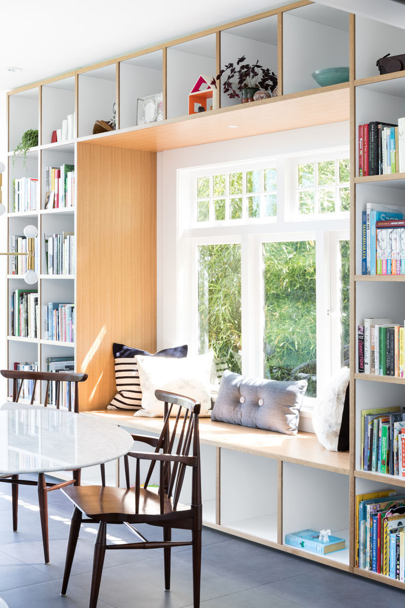 This wood framed built-in window seat is surrounded by open shelving, creating places to store books, decorative items, and toys. #WindowSeat #Shelving #Seating