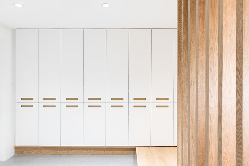 This modern house has a storage area that's filled with white floor-to-ceiling cabinetry. #Storage #Cabinets