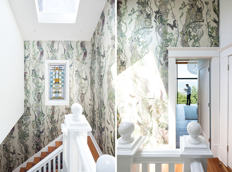 The walls surrounding these stairs are covered in a botanical patterned wallpaper, while a skylight provides ample natural light. #Wallpaper #Staircase #Skylight