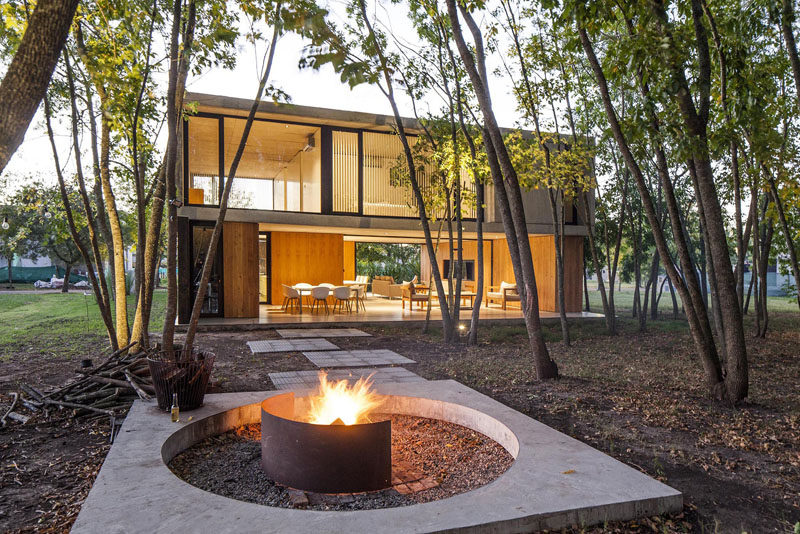 The Bottom Floor Of This Concrete And Wood House Is Almost Completely Open To The Outside