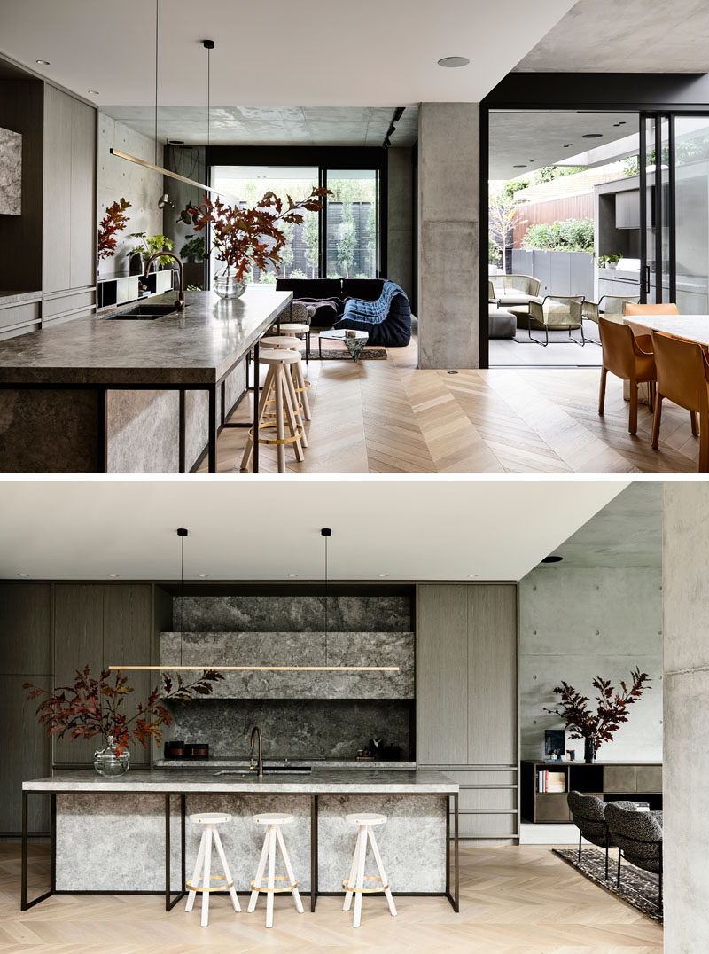 This modern house has an open floor plan, with the kitchen, dining room, and living room, all sharing the same space, and open to the backyard. #ModernKitchen #ModernInteriorDesign