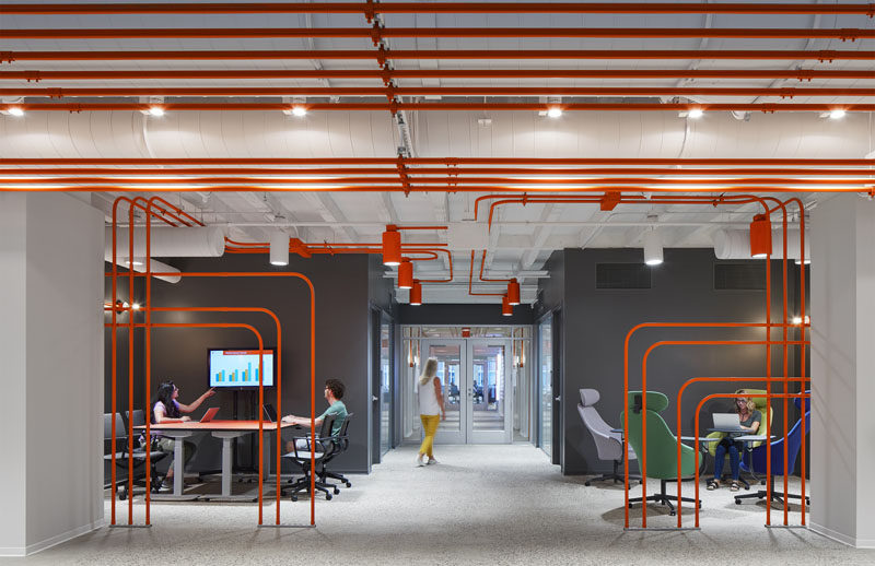 This Office Design Uses Orange Pipes To Guide People Around The Space
