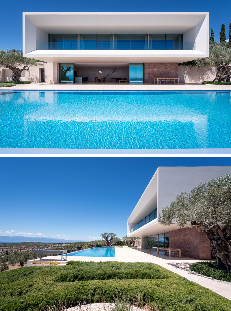 A large infinity pool runs the length of this modern house, while a large deck provides plenty of space for entertaining. #ModernArchitecture #HouseDesign #SwimmingPool