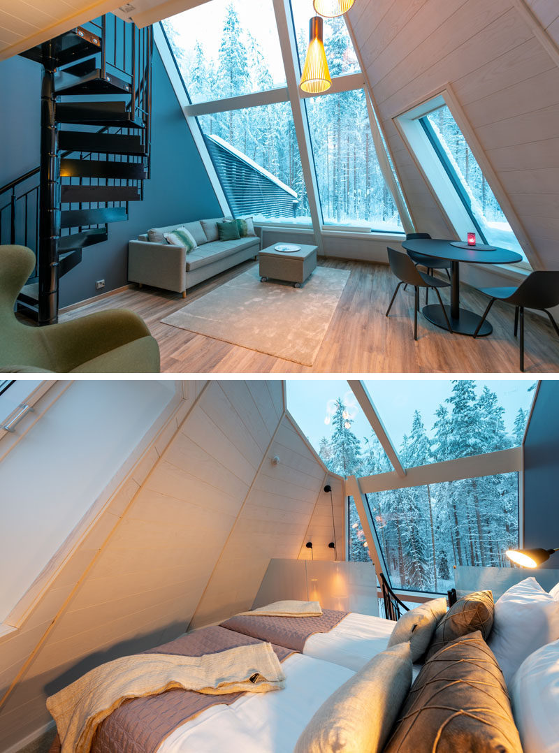 Inside this modern cabin, a wall of windows shows off surrounding area, while inside, there's an open plan living room and dining area. A black spiral staircase leads up to the lofted bedroom, which also has a glass ceiling above the bed, making it easy to stargaze at night. #Cabin #Windows #GlassCeiling