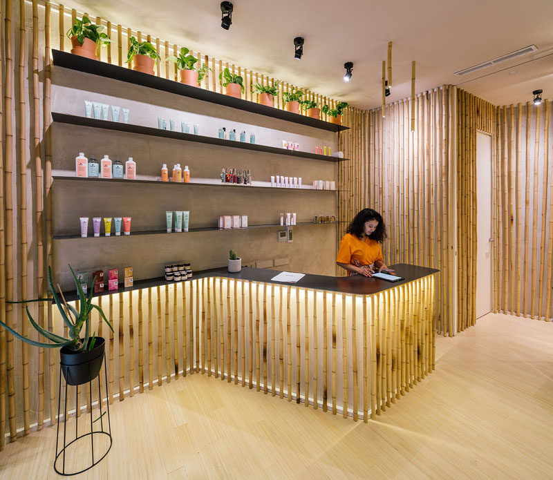 This modern spa has backlit bamboo accents around the service counter, treatment rooms, and hallways. #Bamboo #Spa #InteriorDesign