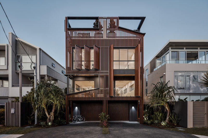 An array of vertical fins have been added to this modern duplex to serve multiple functions including sun-shading, privacy, curation of views, and to modulate the scale of the overall form. #ModernArchitecture #WoodScreens