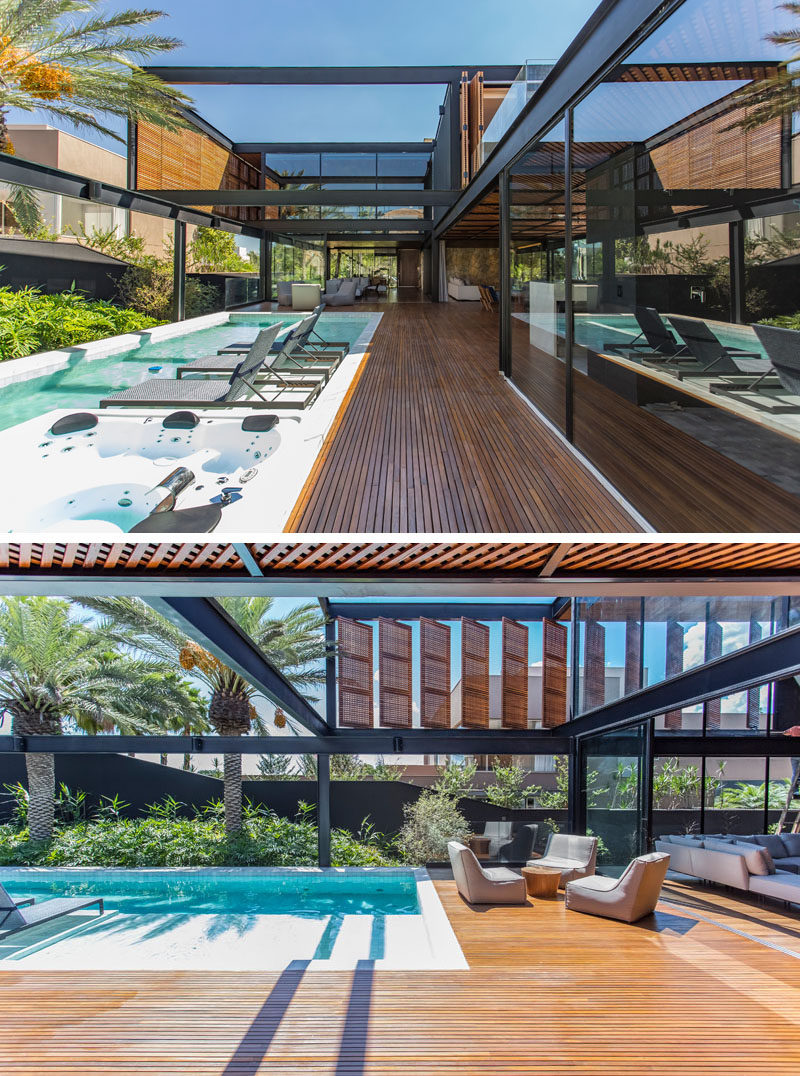 This modern house has an outdoor area that lies adjacent to the swimming pool, while large sliding glass walls open to create an indoor / outdoor living experience. #ModernSwimmingPool #ModernHouse