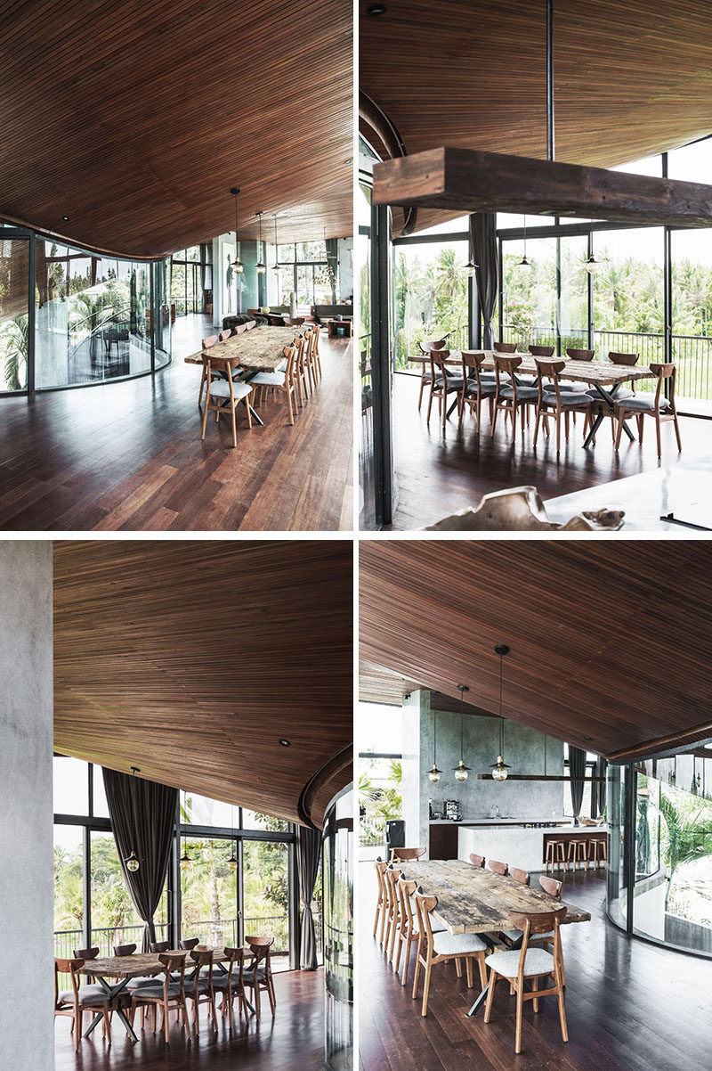 The curved wood ceilings in the dining area of this modern house mimic the lines of the roof, with the designer explaining that it should feel 'like being inside of an instrument'. #DiningRoom #WoodCeiling #CurvedCeiling