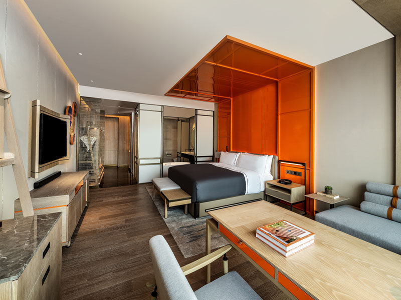 Design Detail ? An Orange Wrap Around Headboard Defines The Bed?s Area In This Hotel Room