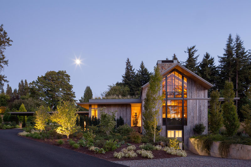 This house, which is reminiscent of a farm structure, is clad in reclaimed barnwood, and has a pitched roof with high windows at each end of the main volume, that flood the home with light. A green roof helps to create an emphasis on integrating the house into its natural surroundings.  #Architecture #FarmhouseModern #GreenRoof #ModernHouse #Landscaping #Windows