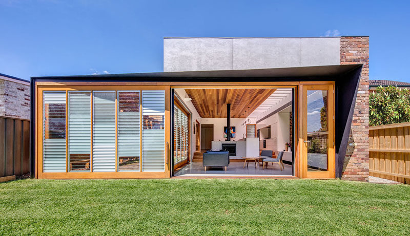 Door Ideas - This modern addition has an oversized sliding glass door, that contains a mix of opaque, clear and frosted glass louvres to allow the family to control air, light and privacy. #Doors #SlidingDoor #DoorIdeas #House Addition