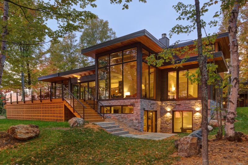 An Old Lakeside Cottage Was Replaced With A New House Made Of Wood, Stone, And Glass