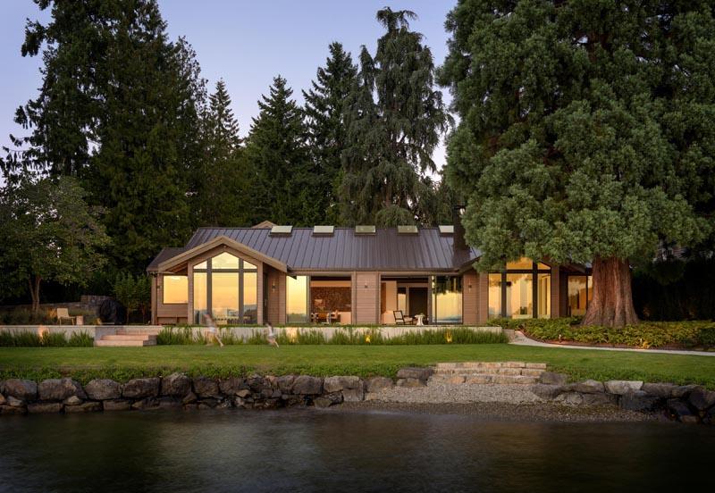 Architecture firm Olson Kundig, has designed the remodel of a dated "log cabin" inspired ranch house, and created an open, flexible and view-oriented home for an active young family. #ModernHouse #ModernRanchHouse #Architecture #LakeHouse