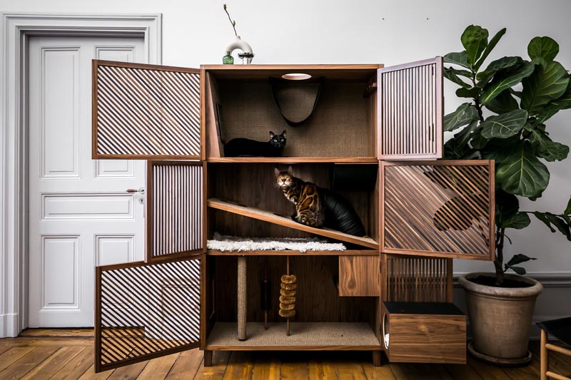 The Cat Flat is a modern three level cabinet designed for cats. It has various textures, scratching poles, brushes, openings and tunnels, as well as a hammock. #CatFurniture #CatCabinet #PetFurniture #Cats #FurnitureDesign #Design