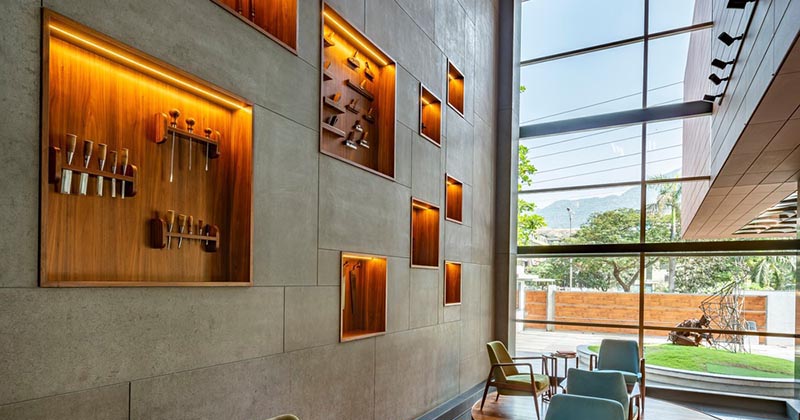 Wood-Lined Shelves With Hidden Lighting Add Interest To These Oversized Lobby Walls