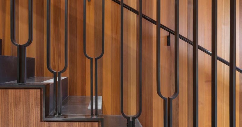 This Black Metal Stair Railing Makes A Strong Statement With Its U-Shaped Design