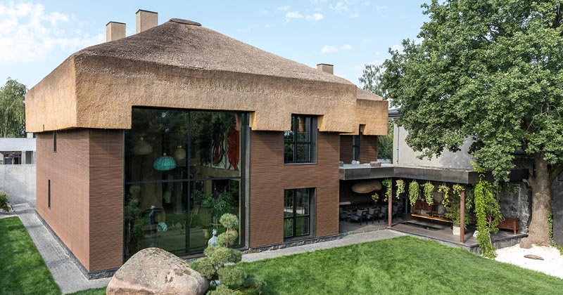 A Thatched Roof Was Placed On Top Of This Modern House