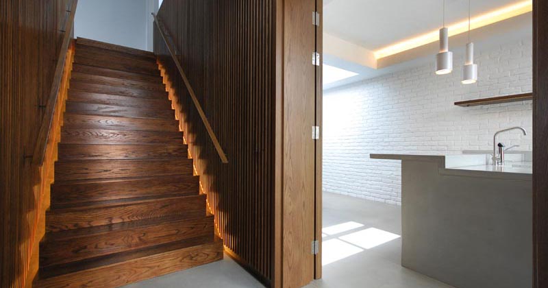 Stairs With Hidden Lighting On Either Side Create A Dramatic Effect When Reflected Off The Wood Slat Walls