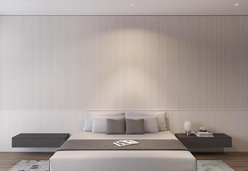 Using wood dowels, the designers of this modern bedroom created a textured accent wall, keeping the lower third as a backdrop for the bed and floating side tables. #WoodAccentWall #TexturedAccentWall