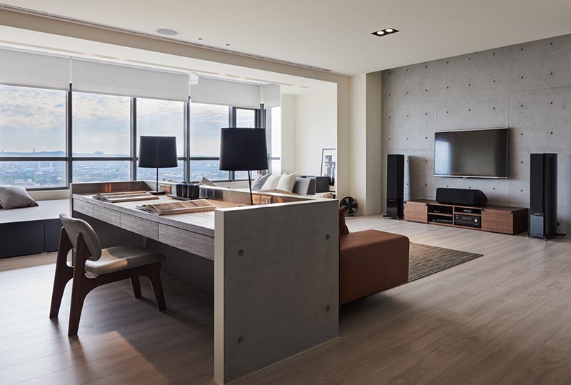 Design firm CAC square together with Guan Pin have designed a modern living room for an apartment in Taiwan, that makes use of the open floor plan to include a dedicated home office. #HomeOffice #WorkAtHome #LivingRoom #Interiors