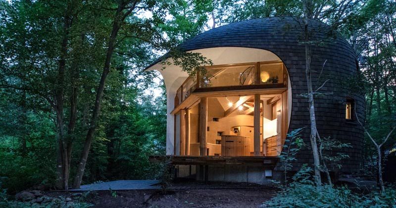 A Small House Shaped Like A Shell Is Surrounded By A Japanese Forest