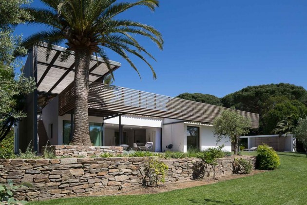 This home in Saint Tropez has a stone wall as part of their landscaping.
