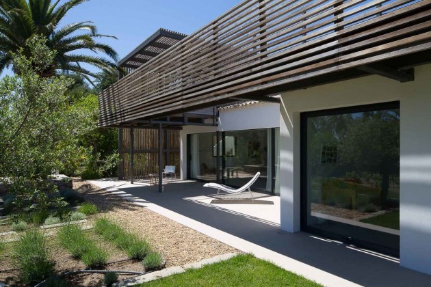 A walkway on a higher level provides shade for the lower outdoor spaces.