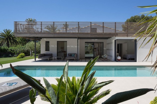 This home in Saint Tropez has a shaded area next to the swimming pool.