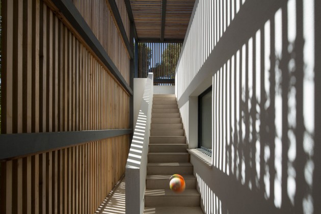 Shade is provided to this staircase by a wooden slat surround.