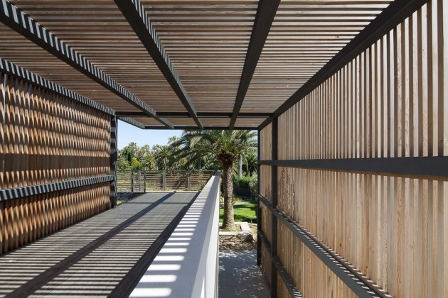 A wooden slat pergola provides shade for this home in Saint Tropez.