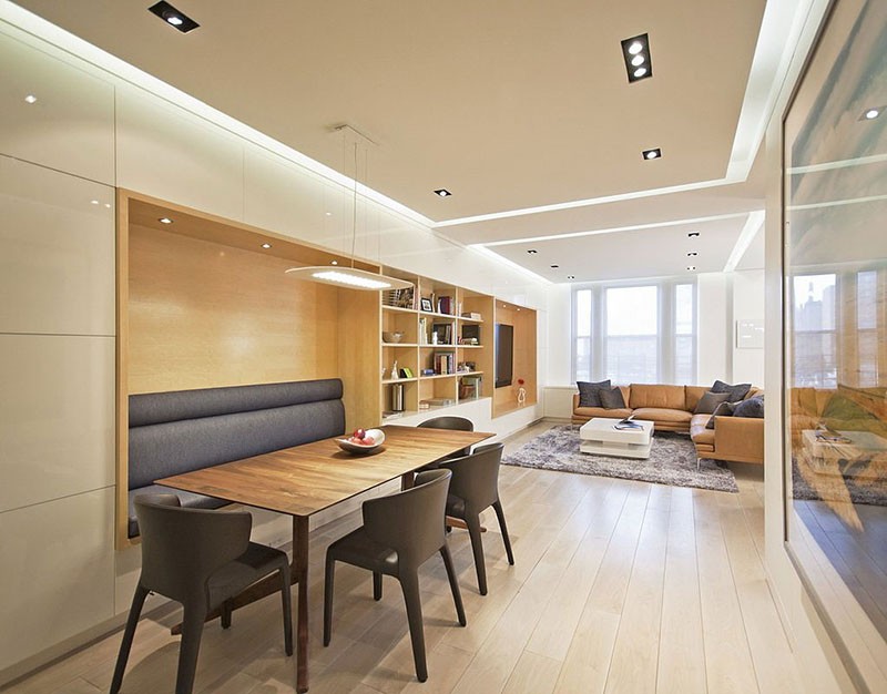 Built-in banquette seating for a dining table that flows into shelving.