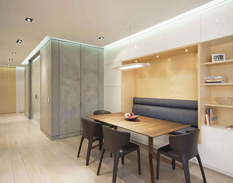 Built-in banquette seating creates a cozy atmosphere for this dining area.