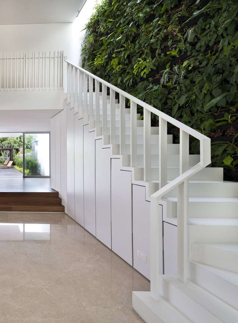 A green wall next to the stairs