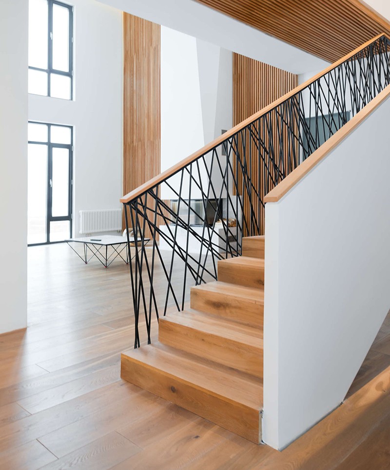 This home designed by Monoloko Design, features custom railings on the stairs and the top floor, made from randomly placed steel supports that have been powder coated black. #StairRails #StairRailing #StairDesign #StairHandrail