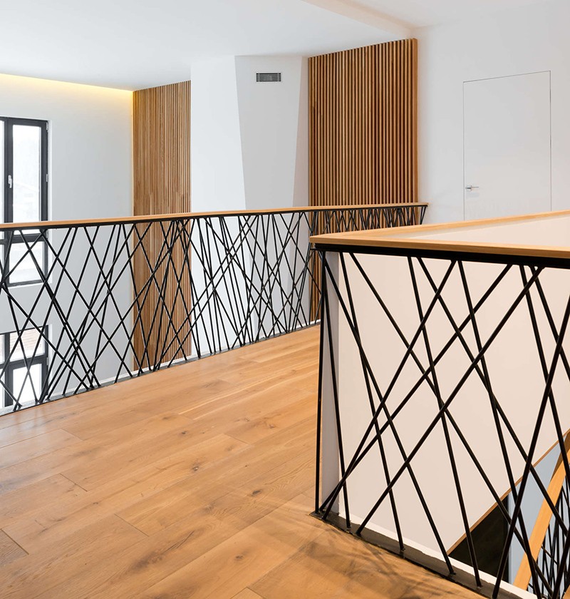 This home designed by Monoloko Design, features custom railings on the stairs and the top floor, made from randomly placed steel supports that have been powder coated black. #StairRails #StairRailing #StairDesign #StairHandrail