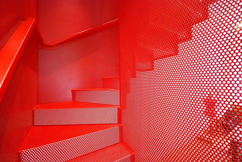 Hanging Red Stairs by Michaelis Boyd Associates