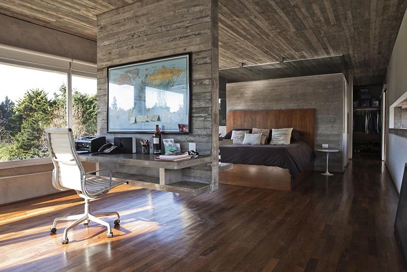 Hanging concrete room divider with a floating desk.