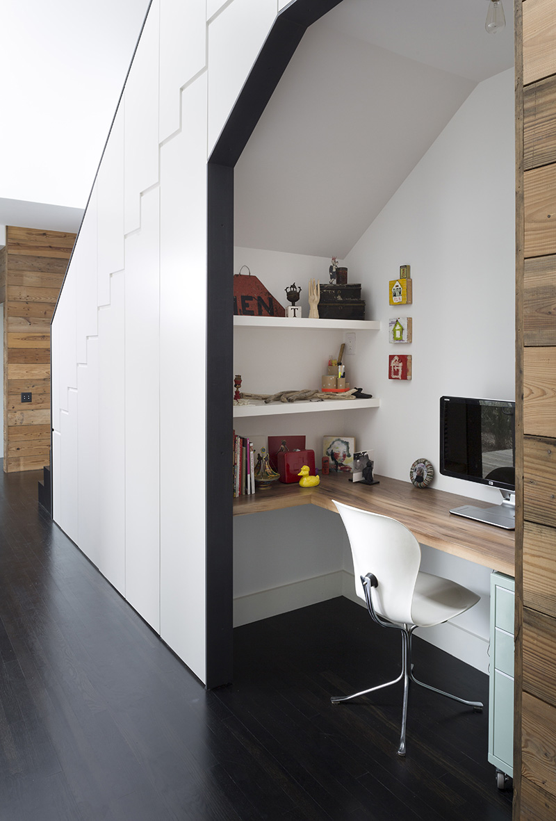 Modern stairs with built-in hidden storage and an office nook.