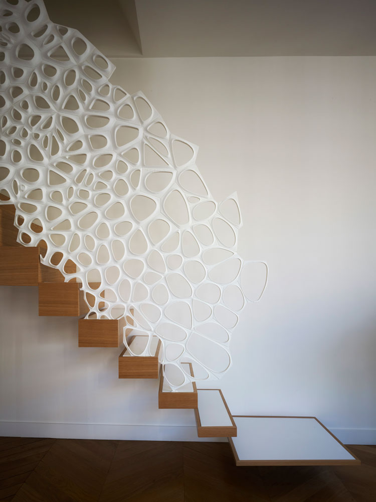 MARC FORNES / THEVERYMANY, together with architect Ammar Eloueini, designed this sculptural handrail made from Corian, for an apartment in Paris, France. #SculpturalHandrail #StairDesign #ModernStairs