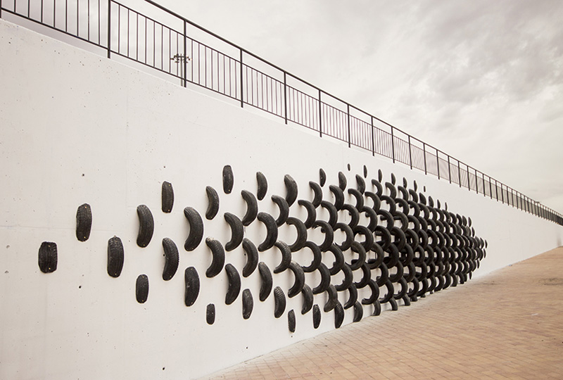 An Artistic Recycled Tire Installation Covers A Wall In Spain