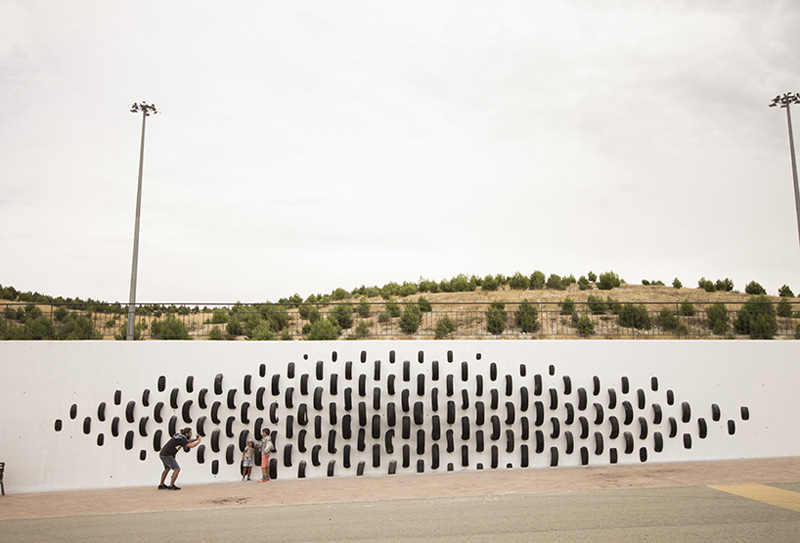 An Artistic Recycled Tire Installation Covers A Wall In Spain