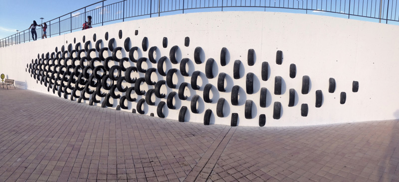 An Artistic Recycled Tire Installation Covers A Wall In Spain