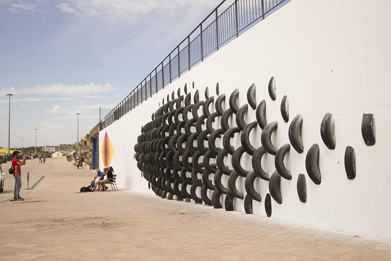 An Artistic Recycled Tire Installation Covers A Wall In Spain