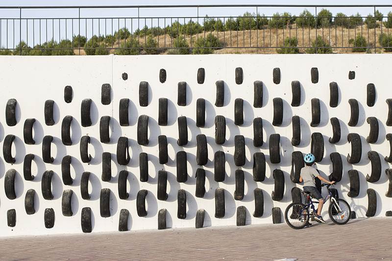 An Artistic Recycled Tire Installation Covers A Wall In Spain