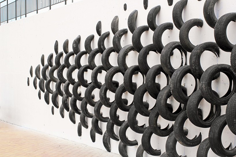 An Artistic Recycled Tire Installation Covers A Wall In Spain