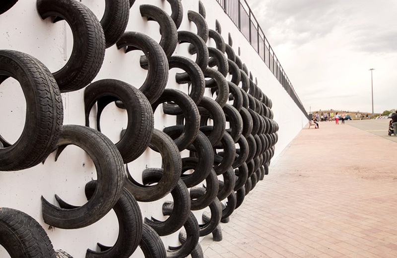 An Artistic Recycled Tire Installation Covers A Wall In Spain