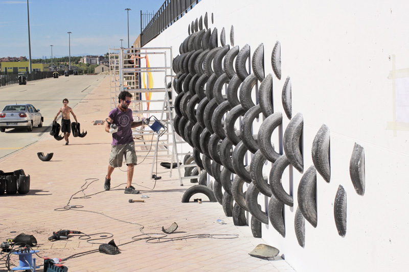 An Artistic Recycled Tire Installation Covers A Wall In Spain